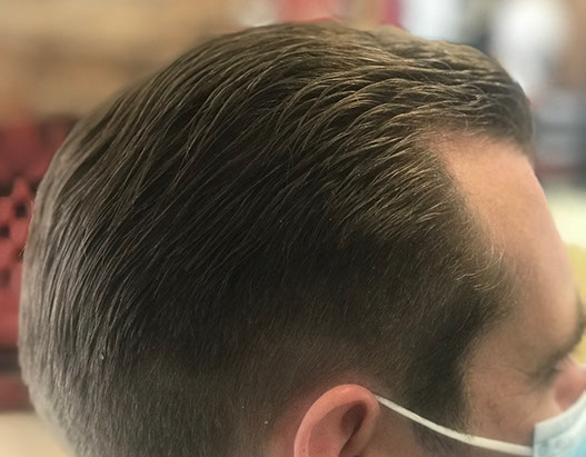 Bruno, cutting hair on the seaside in Porthleven, Cornwall