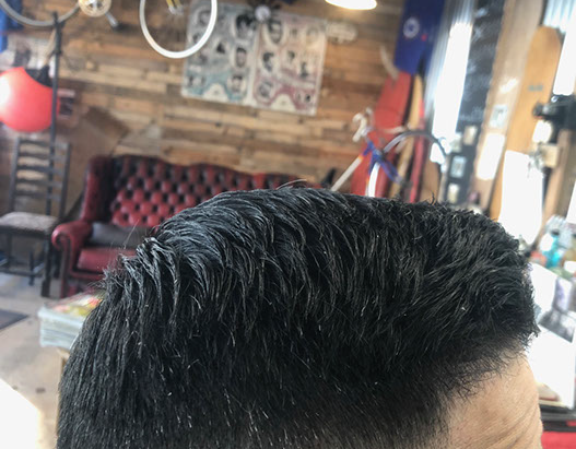 Bruno, cutting hair on the seaside in Porthleven, Cornwall