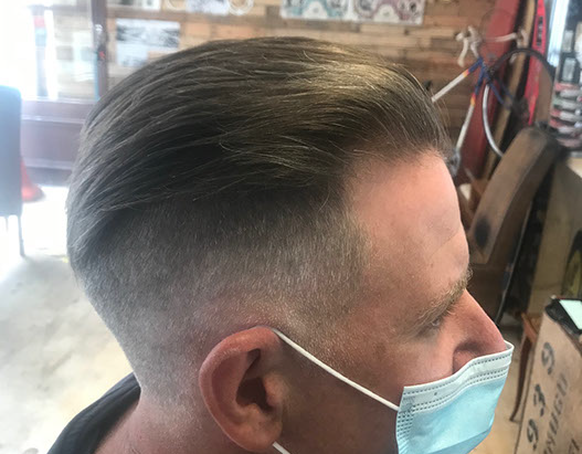 Bruno, cutting hair on the seaside in Porthleven, Cornwall