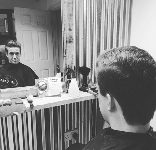 Bruno, cutting hair on the seaside in Porthleven, Cornwall